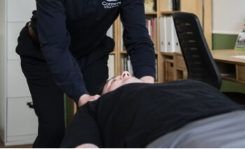 Connect Spinal Health patient having shoulders adjusted