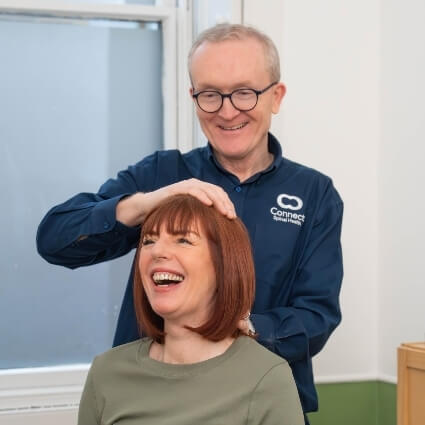 Female patient smiling during an adjustment