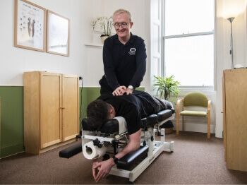 Connect Spinal Health patient laying on adjusting table