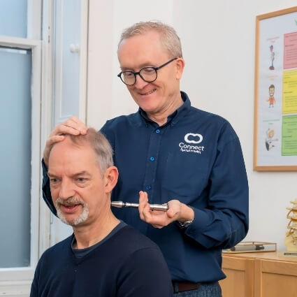 Dr Andrew adjusting patients neck