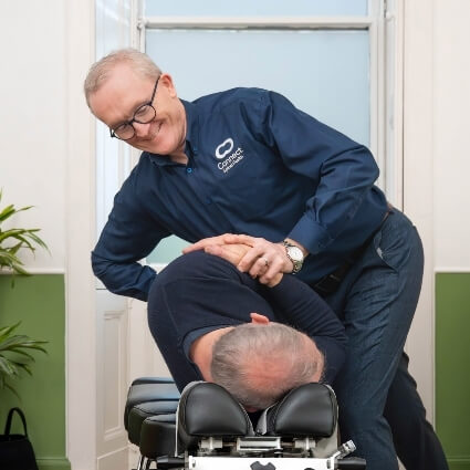 Dr Andrew adjusting patients back