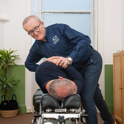 Dr Andrew adjusting patients back