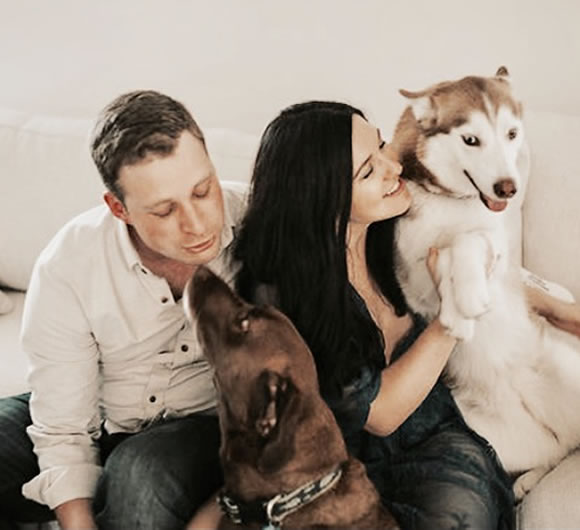 Dr. Amanda and her husband with her dogs
