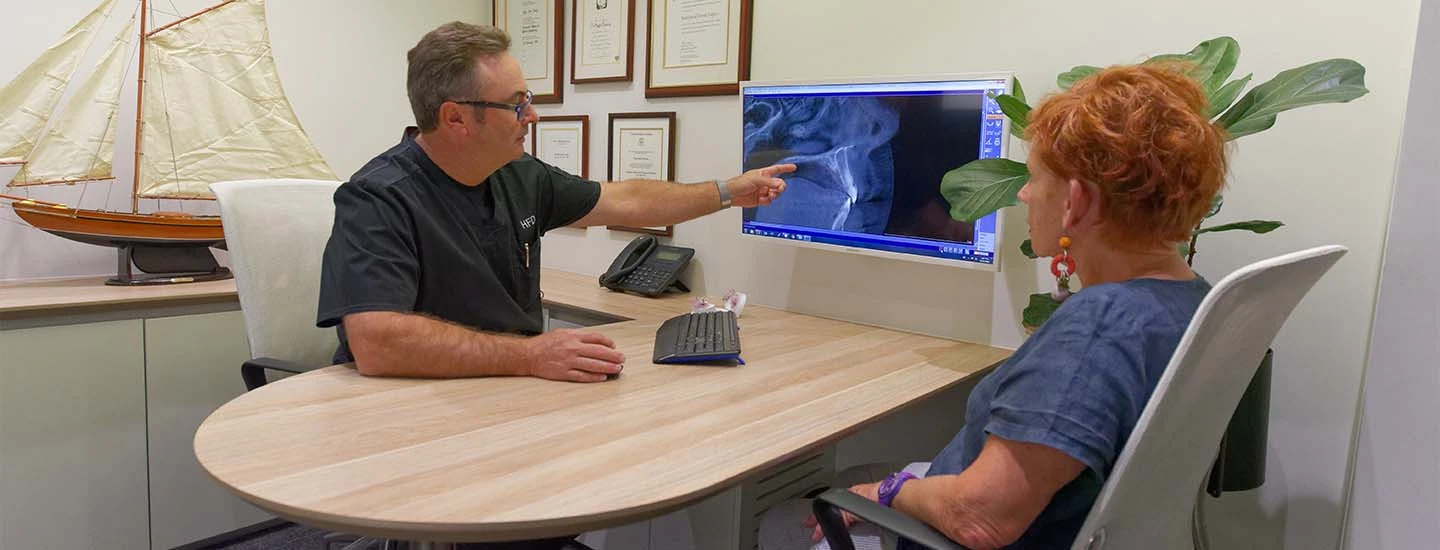 Dentist reviewing xray with patient