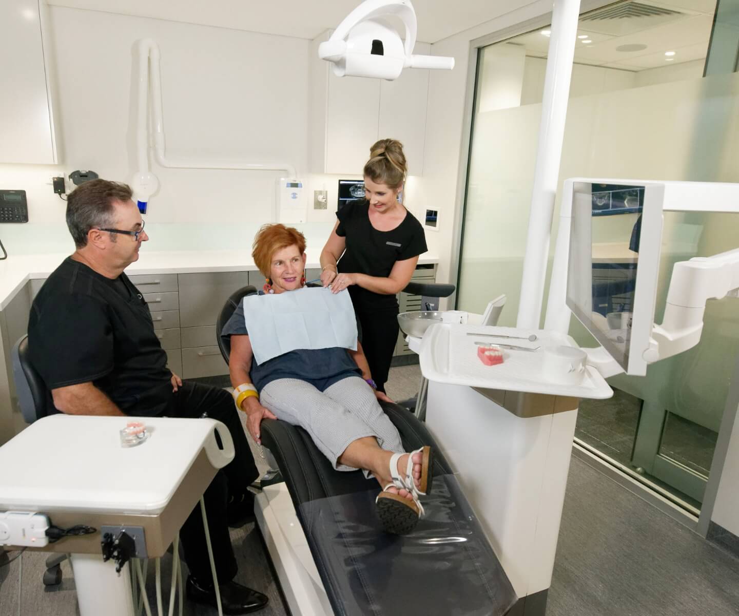Dentist talking to female patient