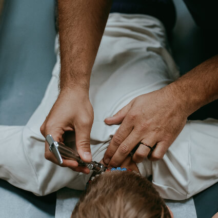 Pediatric Chiropractic activator on neck