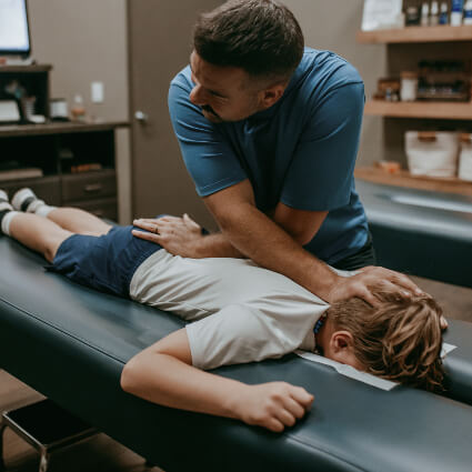 Pediatric Chiropractic child getting table adjustment