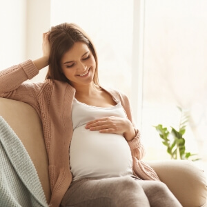 Pregnant woman holding belly