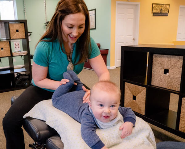 Naperville chiropractor adjusting baby