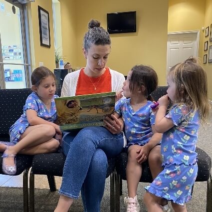 mom reading to kids in our waiting area