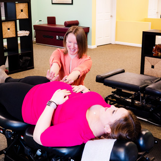 Dr. Carrie adjusting pregnant mom