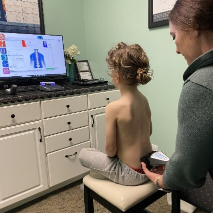 kid having their back scanned