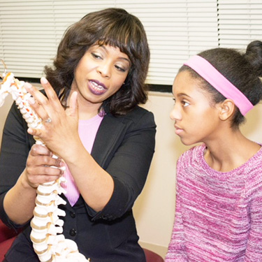 Dr. Miller explaining spine to patient