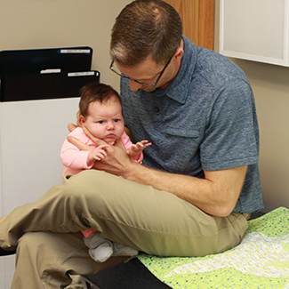 Dr. Steve adjusting infant