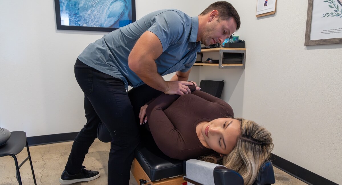 San Marcos chiropractor adjusting a female patient