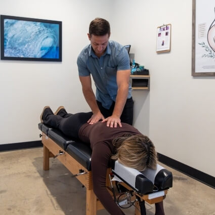 Female patient receiving a chiropractic adjustment