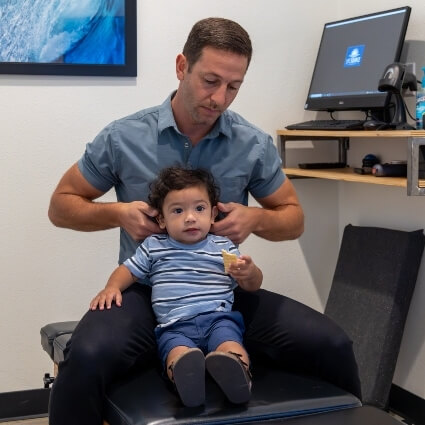 Chiropractor adjusting a pediatric patient