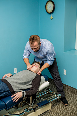 Dr. Krauza adjusting boys neck