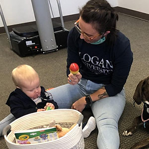 staff member playing with baby