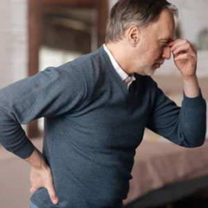 man with back and head pain