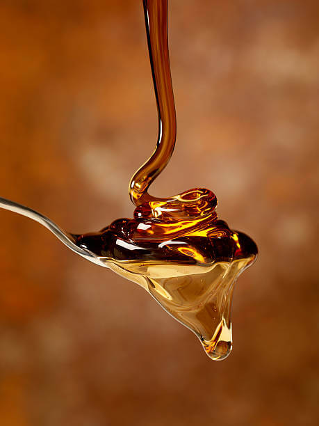 maple syrup dripping onto a spoon