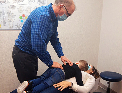 Dr Halvorson adjusting child