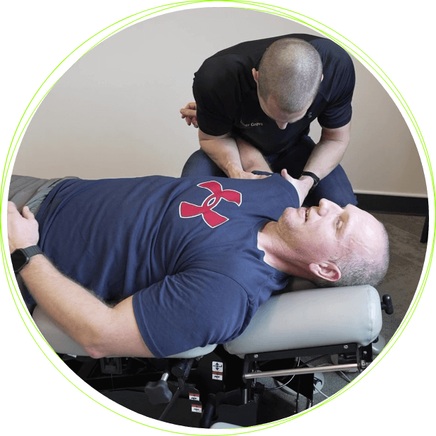 Dr. Ross adjusting man's shoulder