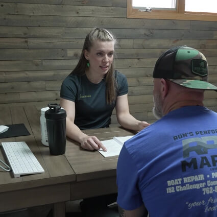 Inver Grove Chiropractic receptionist discussing paperwork with patient