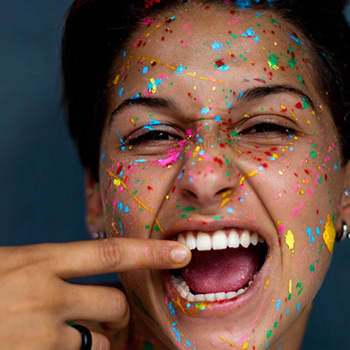 Woman face painted with white teeth