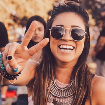 woman wearing shades with peace sign