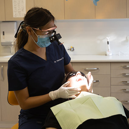 Dentist examining patients mouth