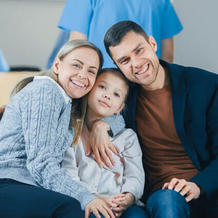 family smiling together in dental waiting room