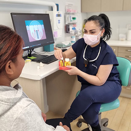 Dr iram talking with patient with mask on