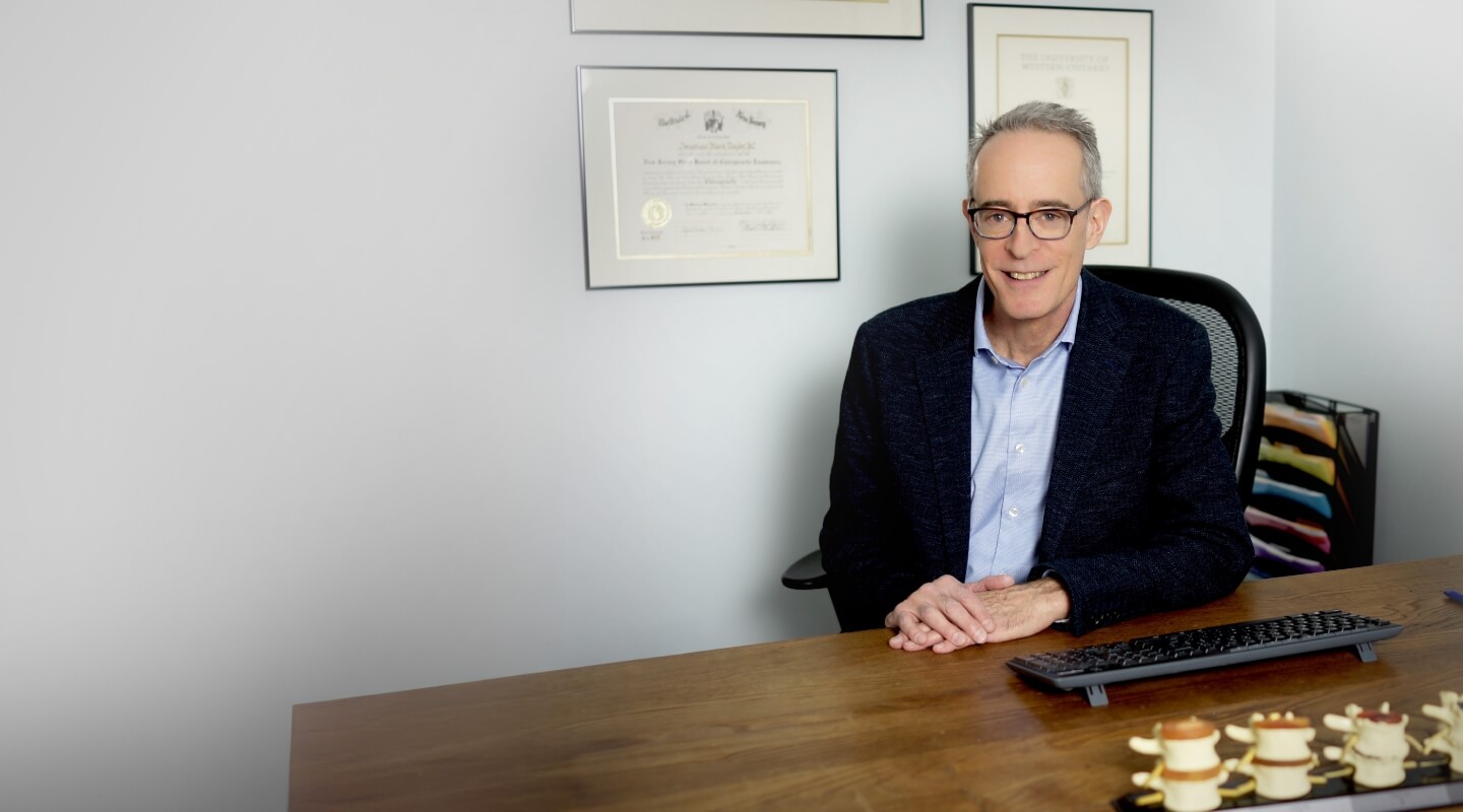 Dr. Taylor smiling behind desk