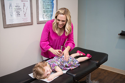 Dr DiNardo adjusting a young patient