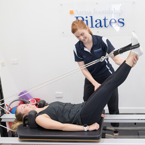 Physiotherapist working on Pilates with client