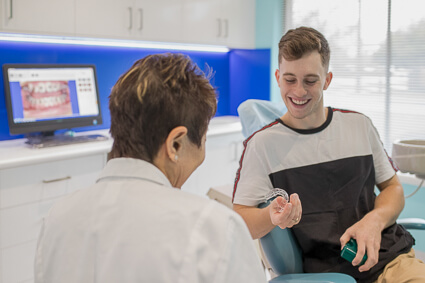 Patient discussing invisible braces with Dr Manaf