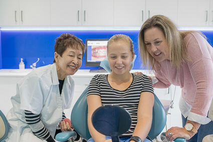 Patient admiring treatment results in mirror