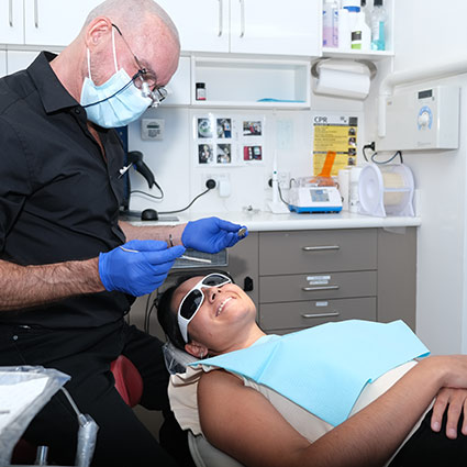 Dentist with patient in chair