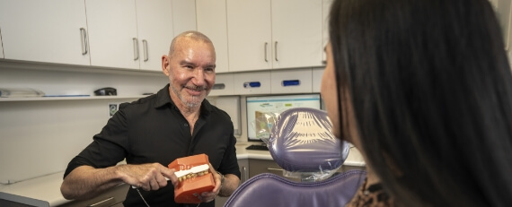 dentist holding teeth model
