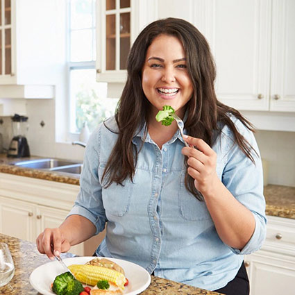 smiling person eating healthy food