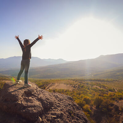 Woman-Standing-On-A-Rock