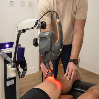 shockwave therapy tool on patients knee