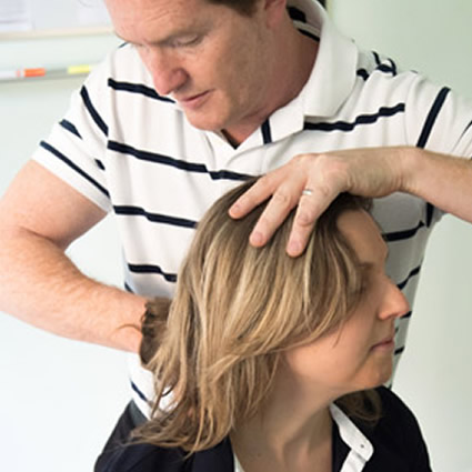 A patient receiving a chiropractic adjustment to the neck