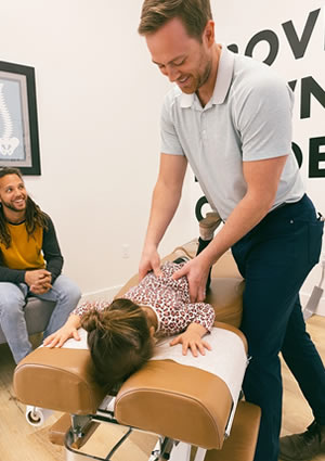 Dr. Tyler adjusting young girl