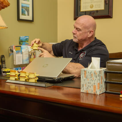 Duluth Chiropractor Dr. Hans holding spine models