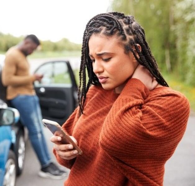 woman holding neck in pain after accident