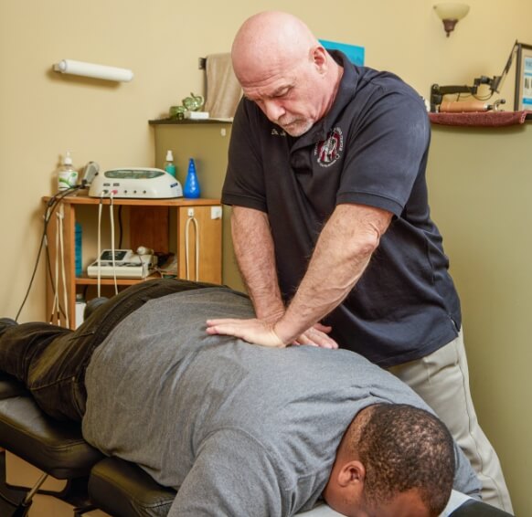 Norcross Chiropractor Dr. Joseph Hans working with patient