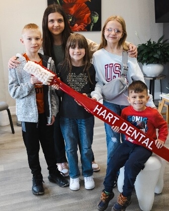 Group of kids posing with giant toothbrush
