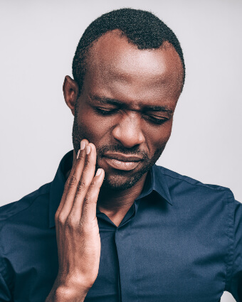 Man in pain touching his face